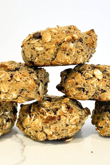 A tempting stack of vegan protein cookies displayed on a countertop, showcasing their golden-brown color and texture.