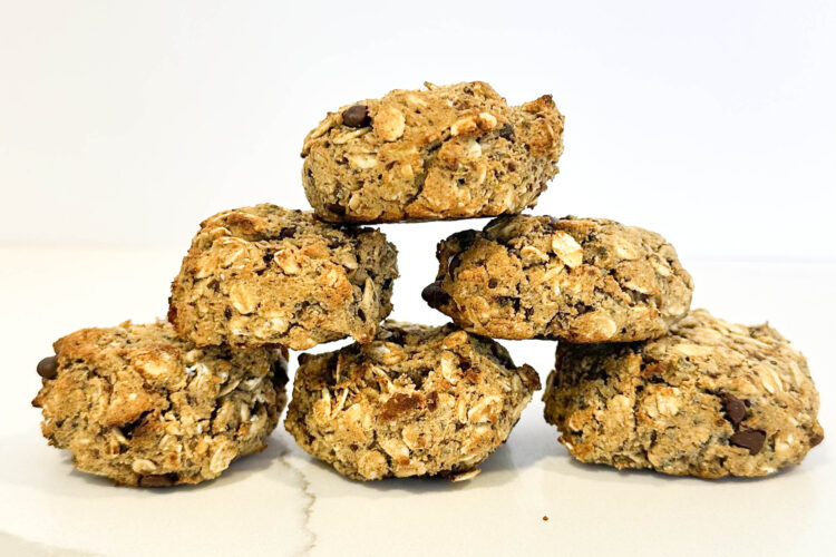 A tempting stack of vegan protein cookies displayed on a countertop, showcasing their golden-brown color and texture.