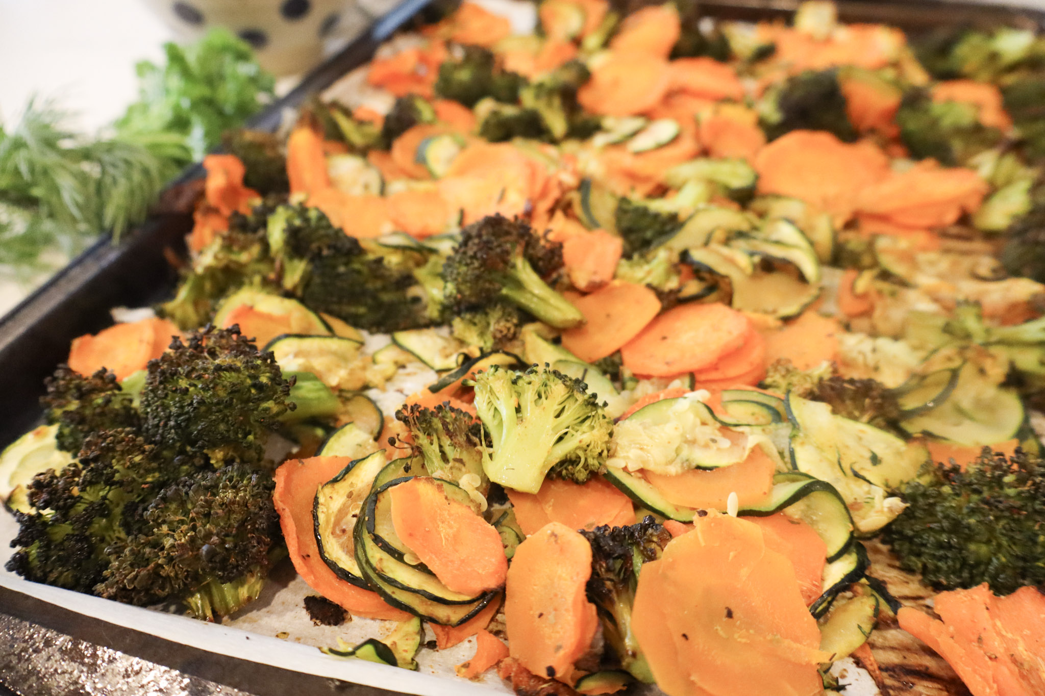 A tray filled with fresh vegetables, prominently featuring vibrant orange carrots and green broccoli florets.
